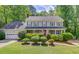 Charming two-story home with well-manicured landscaping and a classic colonial facade at 905 Foxfire Dr, Lawrenceville, GA 30044