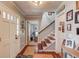Bright and open foyer features hardwood floors and elegant decor, leading into the home at 905 Foxfire Dr, Lawrenceville, GA 30044