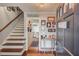Inviting foyer with hardwood floors, staircase, and tastefully decorated walls at 905 Foxfire Dr, Lawrenceville, GA 30044