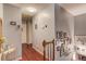 Upstairs hallway featuring hardwood floors and decorative wall art leading to various rooms at 905 Foxfire Dr, Lawrenceville, GA 30044