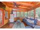 Enclosed sunroom offers wicker seating, a wooden ceiling, and great wooded views at 905 Foxfire Dr, Lawrenceville, GA 30044