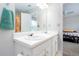 Bright bathroom featuring double sinks, a large mirror, and a glimpse into an adjacent bedroom at 1122 Cotton Gin Dr, Woodstock, GA 30188