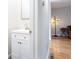 Stylish half bath with a modern vanity, sleek faucet, and hardwood flooring, offering convenience and elegance at 1122 Cotton Gin Dr, Woodstock, GA 30188