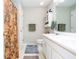 Well-lit bathroom featuring double sinks, white cabinetry, and neutral-toned walls and flooring at 1122 Cotton Gin Dr, Woodstock, GA 30188