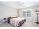 Bright bedroom with ceiling fan, window, and stylish bedside lighting, creating a serene atmosphere at 1122 Cotton Gin Dr, Woodstock, GA 30188