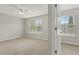 Cozy bedroom featuring soft carpeting, large windows and a ceiling fan at 1122 Cotton Gin Dr, Woodstock, GA 30188