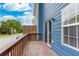 Exterior view of a wooden deck with blue siding and a sliding glass door at 1122 Cotton Gin Dr, Woodstock, GA 30188