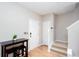 Bright entryway with wood floors, a staircase, and a dark table with two chairs at 1122 Cotton Gin Dr, Woodstock, GA 30188