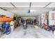 Spacious garage cluttered with motorcycles, bicycles, and storage containers at 1122 Cotton Gin Dr, Woodstock, GA 30188