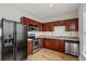 Charming kitchen featuring a stainless steel dishwasher, cherry cabinets and modern appliances at 1122 Cotton Gin Dr, Woodstock, GA 30188