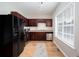 Kitchen with stainless steel appliances, wood cabinets, and ample natural light at 1122 Cotton Gin Dr, Woodstock, GA 30188