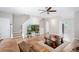 Inviting living room with wood floors, a ceiling fan, and a staircase leading to the upper level at 1122 Cotton Gin Dr, Woodstock, GA 30188
