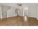 Open-concept living room with hardwood floors, a ceiling fan, and stairs leading to the upper level at 1122 Cotton Gin Dr, Woodstock, GA 30188