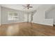 Spacious living room featuring hardwood floors, a ceiling fan, and staircase access at 1122 Cotton Gin Dr, Woodstock, GA 30188