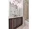 Bathroom featuring a vanity with dark cabinets, a light countertop, and a shower-tub combination with neutral tiling at 237 Libby Ln, Canton, GA 30115