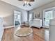 Bright Bedroom with a white crib, light gray walls, a ceiling fan, and an adjacent bathroom for convenience at 237 Libby Ln, Canton, GA 30115