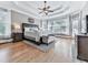 Bright bedroom with large windows, tray ceiling, hardwood floors, and a cozy seating area at 237 Libby Ln, Canton, GA 30115