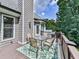 Cozy outdoor deck with seating, a grill, and lush green trees as background at 237 Libby Ln, Canton, GA 30115