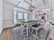 Bright dining room features coffered ceilings, bay window, modern chandelier and hardwood flooring at 237 Libby Ln, Canton, GA 30115