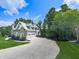 Elegant home with three car garage and ample parking surrounded by lush green trees and manicured lawn at 237 Libby Ln, Canton, GA 30115