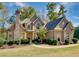 Charming two-story home featuring stone accents, lush landscaping, and a welcoming entrance at 237 Libby Ln, Canton, GA 30115