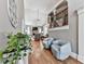 Foyer with hardwood floors, a plant, seating, and an open view into the living room and upstairs area at 237 Libby Ln, Canton, GA 30115
