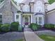 Close-up of home's front door framed by columns, flower pots, and manicured bushes at 237 Libby Ln, Canton, GA 30115
