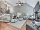Spacious living room with fireplace, hardwood floors, a large ceiling fan, and neutral tones at 237 Libby Ln, Canton, GA 30115