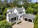 Aerial view of a home showcasing its landscaping, two car garage, and charming screened porch at 3773 Randall Se Rd, Atlanta, GA 30339