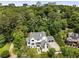 Expansive aerial view of a stunning home surrounded by lush greenery and mature trees, complemented by the city skyline at 3773 Randall Se Rd, Atlanta, GA 30339