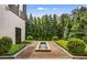 A well-maintained backyard featuring a contemporary water feature and manicured hedges for serene outdoor living at 3773 Randall Se Rd, Atlanta, GA 30339