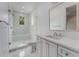 A bright bathroom features glass shower doors, and a white vanity with a quartz countertop at 3773 Randall Se Rd, Atlanta, GA 30339