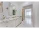 Bright bathroom featuring marble countertops and floors, a soaking tub visible in the distance at 3773 Randall Se Rd, Atlanta, GA 30339