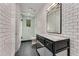 Modern bathroom featuring white subway tiles, glass shower door, and dark vanity with marble countertop at 3773 Randall Se Rd, Atlanta, GA 30339