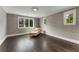 Bedroom with neutral walls, dark wood floors, and multiple windows at 3773 Randall Se Rd, Atlanta, GA 30339