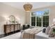 Bright bedroom with a large window, chandelier, and a dresser at 3773 Randall Se Rd, Atlanta, GA 30339