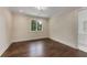 A bright bedroom offers natural light and dark hardwood floors, conveniently located next to the bathroom at 3773 Randall Se Rd, Atlanta, GA 30339
