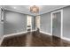 A stylish bedroom boasts warm hardwood floors and a contemporary light fixture for a modern look at 3773 Randall Se Rd, Atlanta, GA 30339