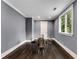 A modern dining room with neutral walls, hardwood floors and a stylish glass table at 3773 Randall Se Rd, Atlanta, GA 30339