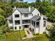 Stunning aerial view of modern home featuring lush landscaping, multiple chimneys, and stylish architecture at 3773 Randall Se Rd, Atlanta, GA 30339