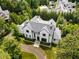 Aerial view of a stately home featuring impeccable landscaping, a circular driveway, and a charming exterior design at 3773 Randall Se Rd, Atlanta, GA 30339