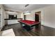 Entertainment space with a pool table, custom wet bar, and unique lighting fixture at 3773 Randall Se Rd, Atlanta, GA 30339