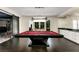Spacious game room featuring a red pool table, elegant lighting, and mirrored wet bar for entertainment at 3773 Randall Se Rd, Atlanta, GA 30339