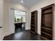 Hallway with dark wood floors, stylish bookshelves, and view into billiards room at 3773 Randall Se Rd, Atlanta, GA 30339