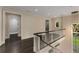 Hallway with dark wood floors, white banister and trim, and view to a rear yard at 3773 Randall Se Rd, Atlanta, GA 30339