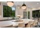 Bright kitchen with a large island with seating, stainless steel appliances, and a large window with a view of the trees at 3773 Randall Se Rd, Atlanta, GA 30339