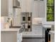 A modern kitchen with stainless steel appliances, white cabinets, and white subway tile backsplash at 3773 Randall Se Rd, Atlanta, GA 30339