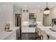 Bright kitchen featuring a large island with marble countertops, stainless steel appliances, and dark hardwood floors at 3773 Randall Se Rd, Atlanta, GA 30339