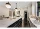 Bright kitchen featuring a large island with marble countertops, stainless steel appliances, and dark hardwood floors at 3773 Randall Se Rd, Atlanta, GA 30339