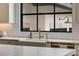 Farmhouse sink with marble countertop and gold faucet fixtures are featured in the kitchen at 3773 Randall Se Rd, Atlanta, GA 30339